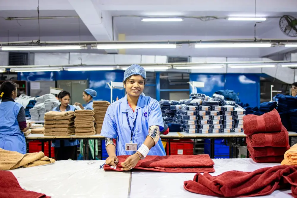 Factory workers folding towels in a textile unit