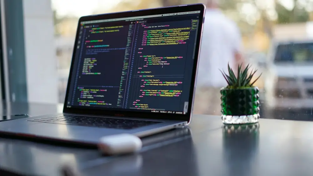 Laptop showing code in a developer workspace