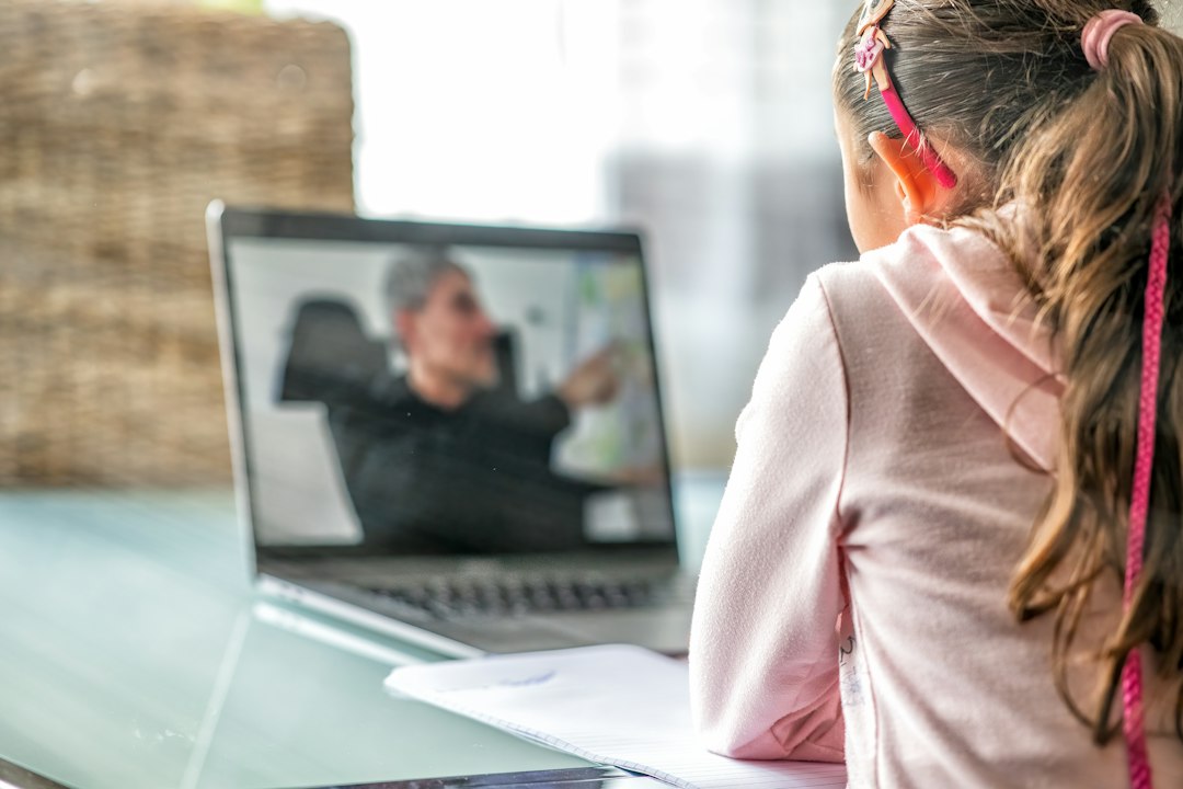 Student following an online science tutoring lesson on her laptop
