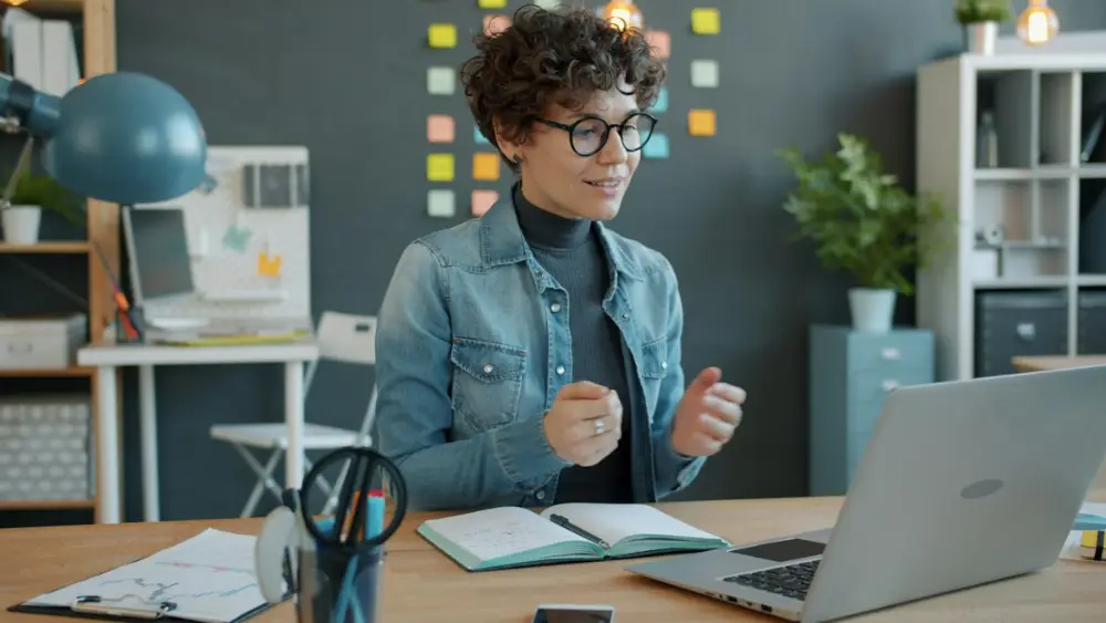 Online science tutor speaking to a student on a laptop video call