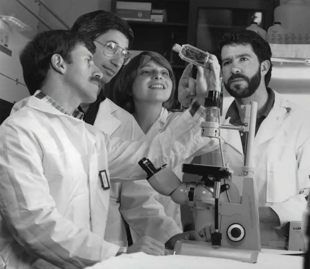 Scientists examining samples under a microscope