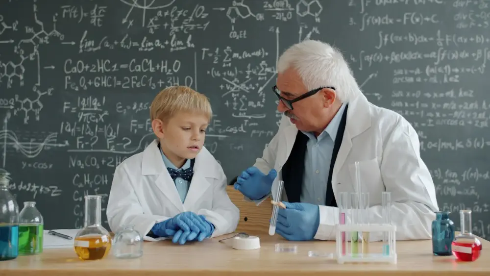 Student discussing a chemistry experiment with his tutor