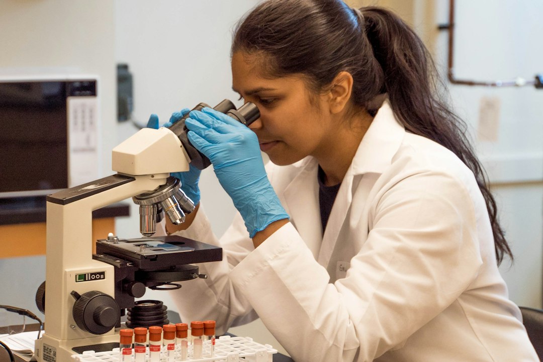 Student observing samples under a microscope