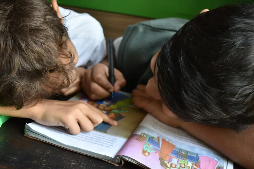 Student writing in a notebook during a home tuition session