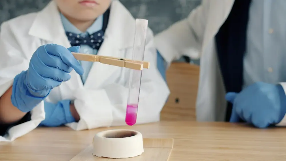 Teacher and student heating a test tube in a science experiment