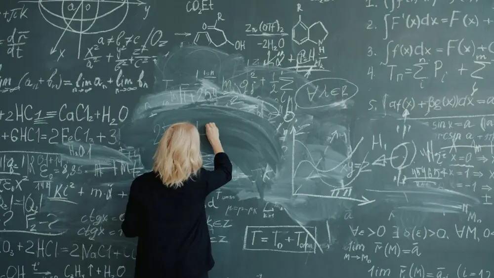 Teacher writing on the board during a class