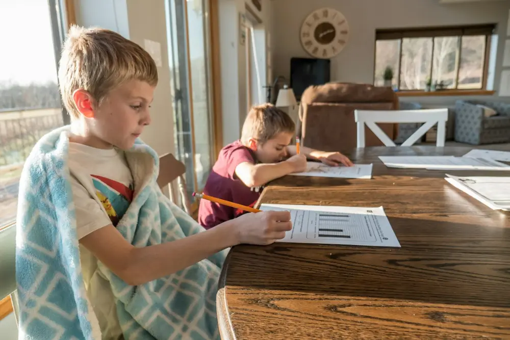Young student practising writing during private tuition
